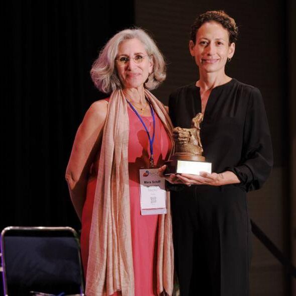 Dr. Mara Schiff, NACRJ Founding Board Member, presents Thalia Gonzalez with the Research/Journalism Award in Community and Restorative Justice at the July 2022 national conference. Thalia joined the NACRJ Board of Directors in fall 2022.